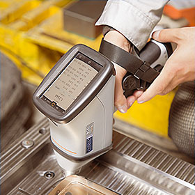 a man's hand holding spectrum analyzing steel