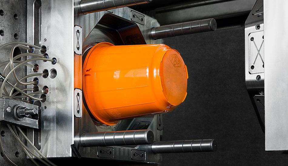 an orange bucket in injection molding process