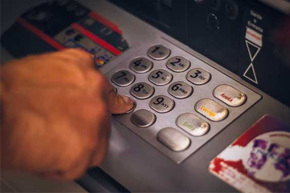 Person pressing keys at an atm